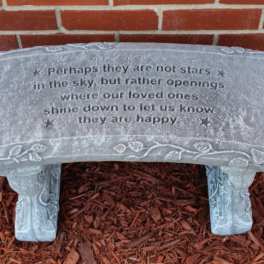 Stone memorial bench with an engraved quote