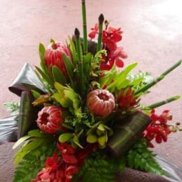 Tropical bouquet with red flowers and tall green stems