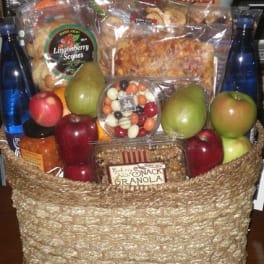 Gift basket with fruit, snacks, and bottled drinks