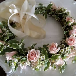 Pink rose floral wreath with white ribbon