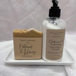 Soap bar and lotion bottle on a white tray