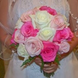 Bride holding a bouquet of pink and white roses