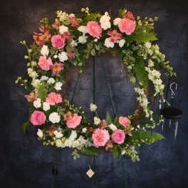 Pink and white floral wreath on a standing easel