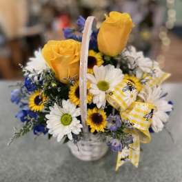Basket of yellow roses and daisies with a yellow ribbon