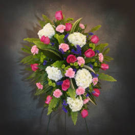 Standing floral spray with pink roses, white hydrangeas, and carnations
