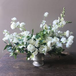 White floral arrangement in a silver vase
