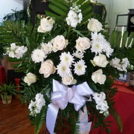 White rose and chrysanthemum standing spray with a white ribbon bow
