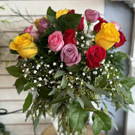 Bouquet of multicolored roses in a glass vase