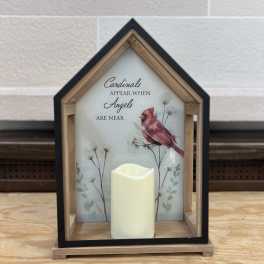 House-shaped memorial sign with a cardinal and a candle