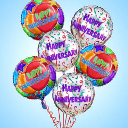 Cluster of colorful "Happy Anniversary" balloons on a blue background