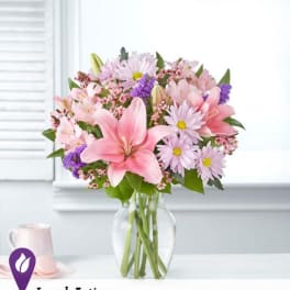 Pink and lavender mixed bouquet in a clear glass vase