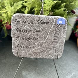 Memorial plaque with an eagle and engraved text on a stand