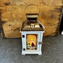 White memorial lantern with a gold top and a cardinal design on the front
