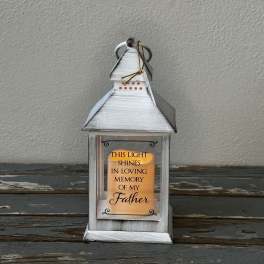 White lantern with a memorial candle for father