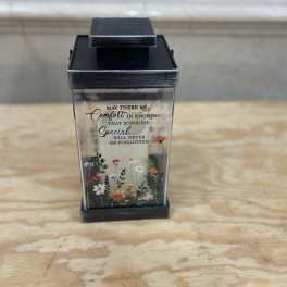 Black memorial lantern with a printed sympathy message and small floral design