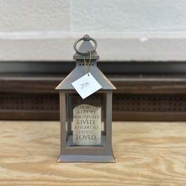 Gray lantern with a memorial candle inside