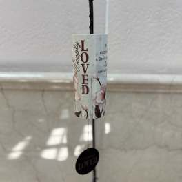 Hanging memorial wind chime with floral print and the word Loved