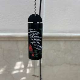 Black hanging wind chime with a red bird and printed quote