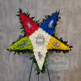 Large five-point floral tribute in red, blue, white, green, and yellow