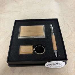 Gift set with a compact mirror, keychain, and pen in a black box
