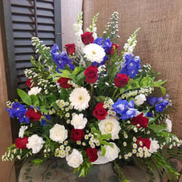 Large mixed bouquet with red and white roses, blue flowers, and white daisies
