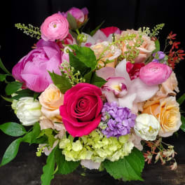 Mixed bouquet of pink, peach, white, and purple flowers