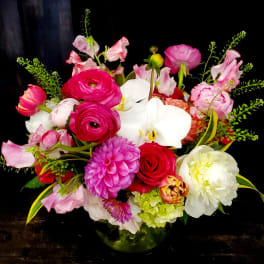 Mixed pink and white floral arrangement in a glass vase
