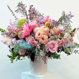 Large pastel bouquet in a white cylindrical vase
