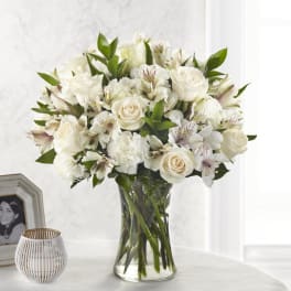 White rose and alstroemeria bouquet in a clear glass vase