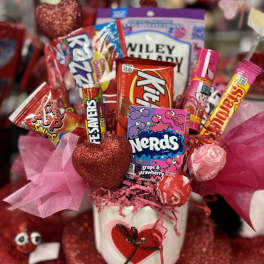 Candy bouquet in a white pot with pink tissue and heart decorations
