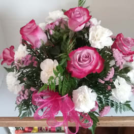 Pink and white rose bouquet with carnations and a pink ribbon