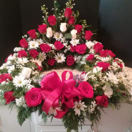 Heart-shaped floral wreath with red and white roses and daisies