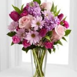 Pink and purple mixed bouquet in a clear glass vase