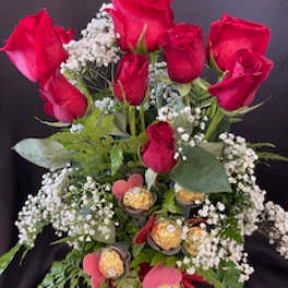 Bouquet of red roses with baby's breath and chocolates