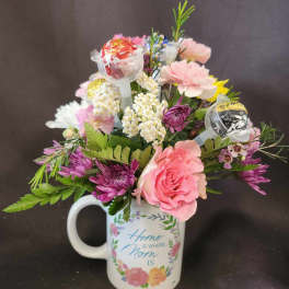 Mixed pink and white flower arrangement with candy pops in a Mom-themed mug.