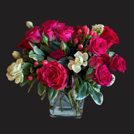 Pink and red rose bouquet in a clear glass vase