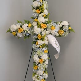 Cross-shaped floral standing spray with white and yellow flowers