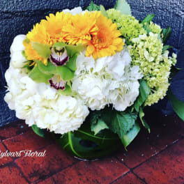 White and yellow floral arrangement with orchids and hydrangeas