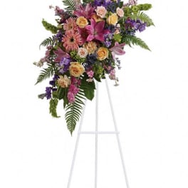 Large floral spray on a white easel with pink, purple, and yellow blooms