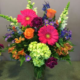 Colorful mixed flower arrangement in a clear glass vase