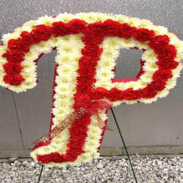 Red and white floral letter P on a stand