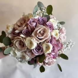 Bouquet of pastel roses with white filler flowers and eucalyptus