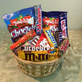 Basket filled with assorted candy bars and snack packs