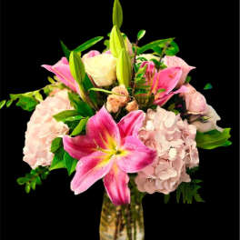 Pink lilies and hydrangeas in a glass vase
