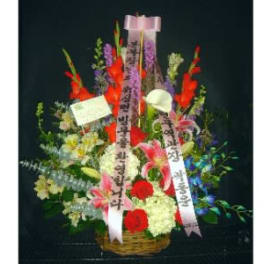 Tall mixed flower basket with red, pink, and white blooms and Korean message ribbons.
