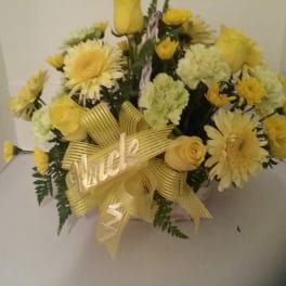 Yellow bouquet with daisies, carnations, and roses tied with a ribbon