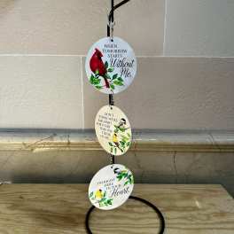 Hanging memorial ornament with three bird-themed discs and text