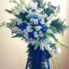 White and blue floral standing spray on an easel