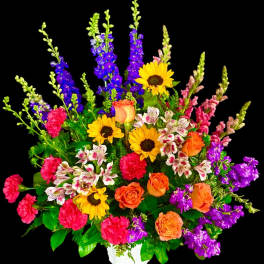Colorful mixed flower arrangement in a white vase with sunflowers and roses
