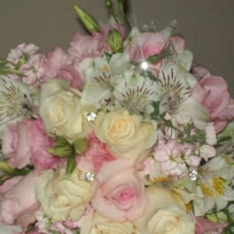 Bouquet of pale pink and cream roses with white striped alstroemeria